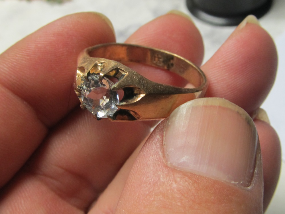 Gold ring with Hallmark Antiques Board