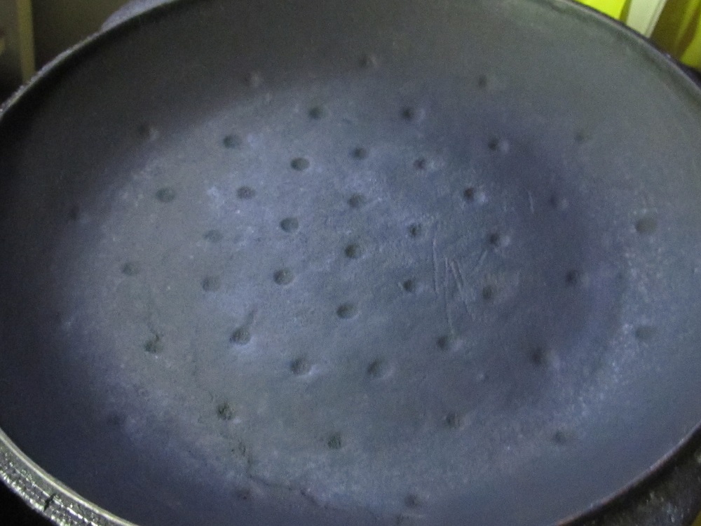 Old cast iron lid with dots