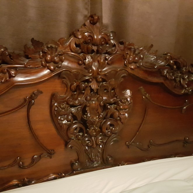 Bed closeup headboard carving.jpg
