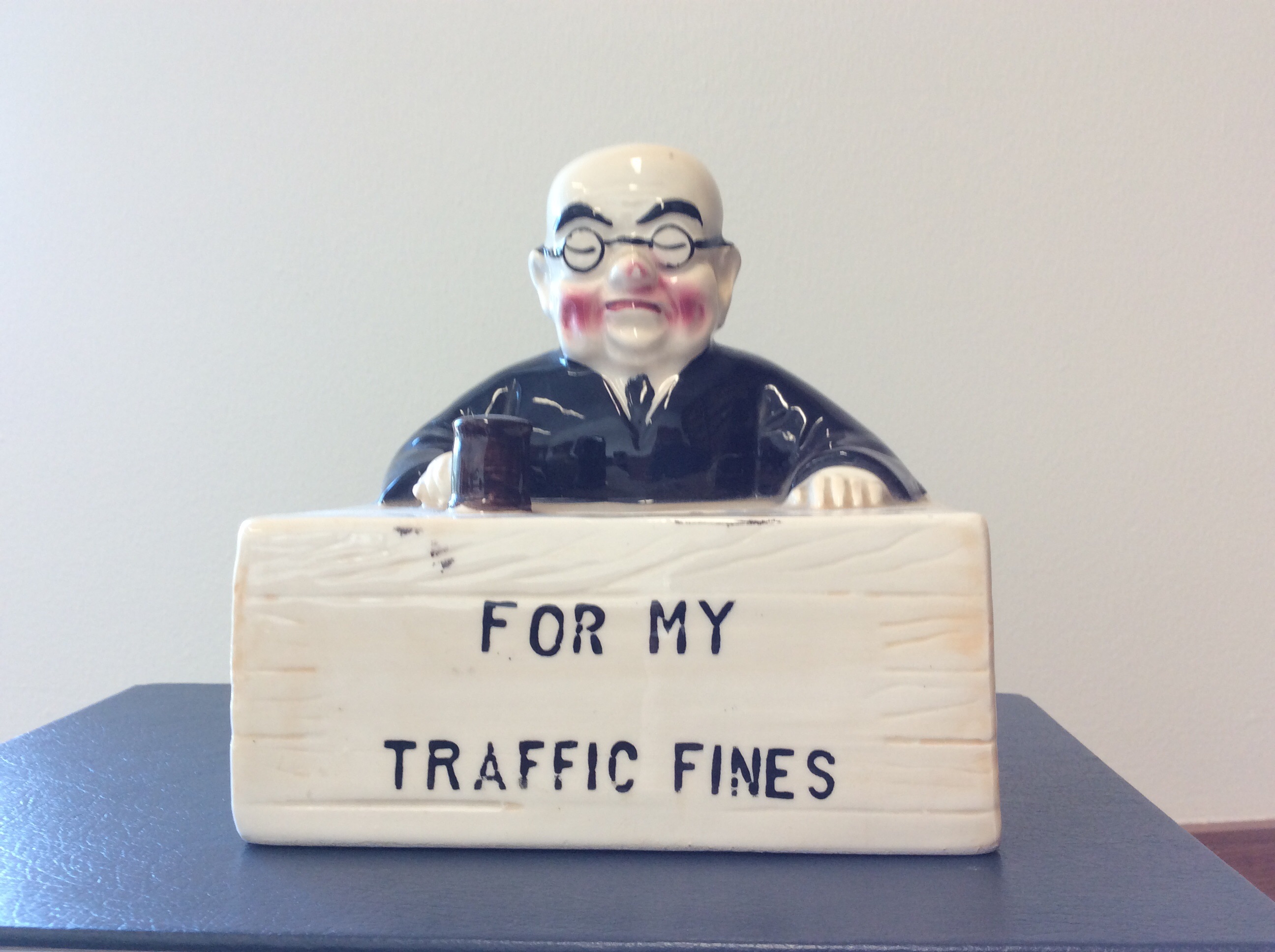 What is the origin of this judge piggy bank? Antiques Board