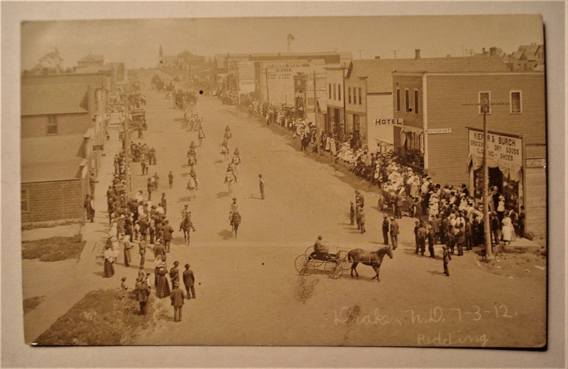 postcard Drake North Dakota parade 1912 business district.jpg