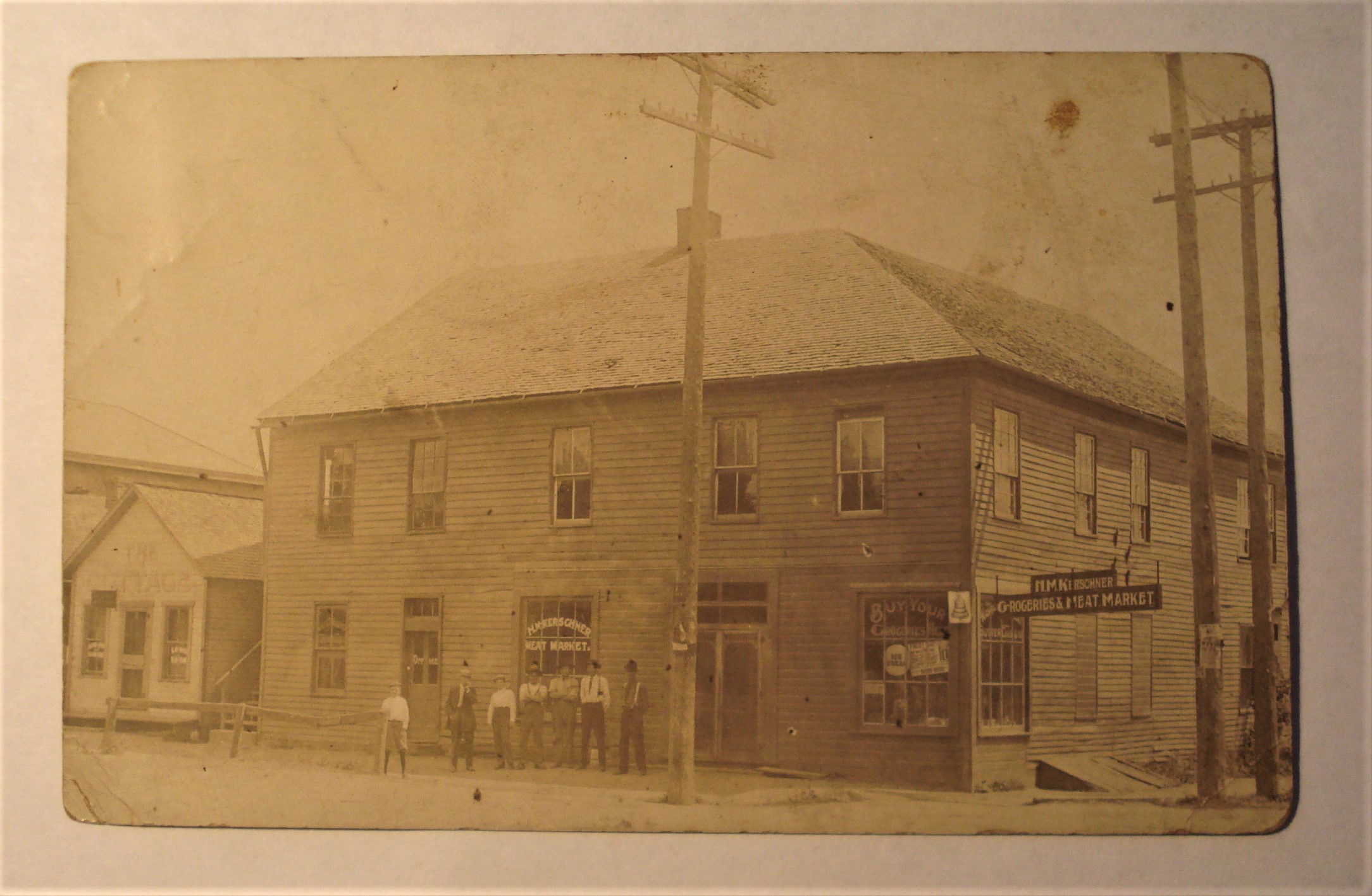 postcard storefront grocery and meat market.jpg