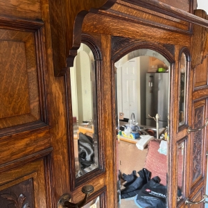 Wooden rod above mirrors