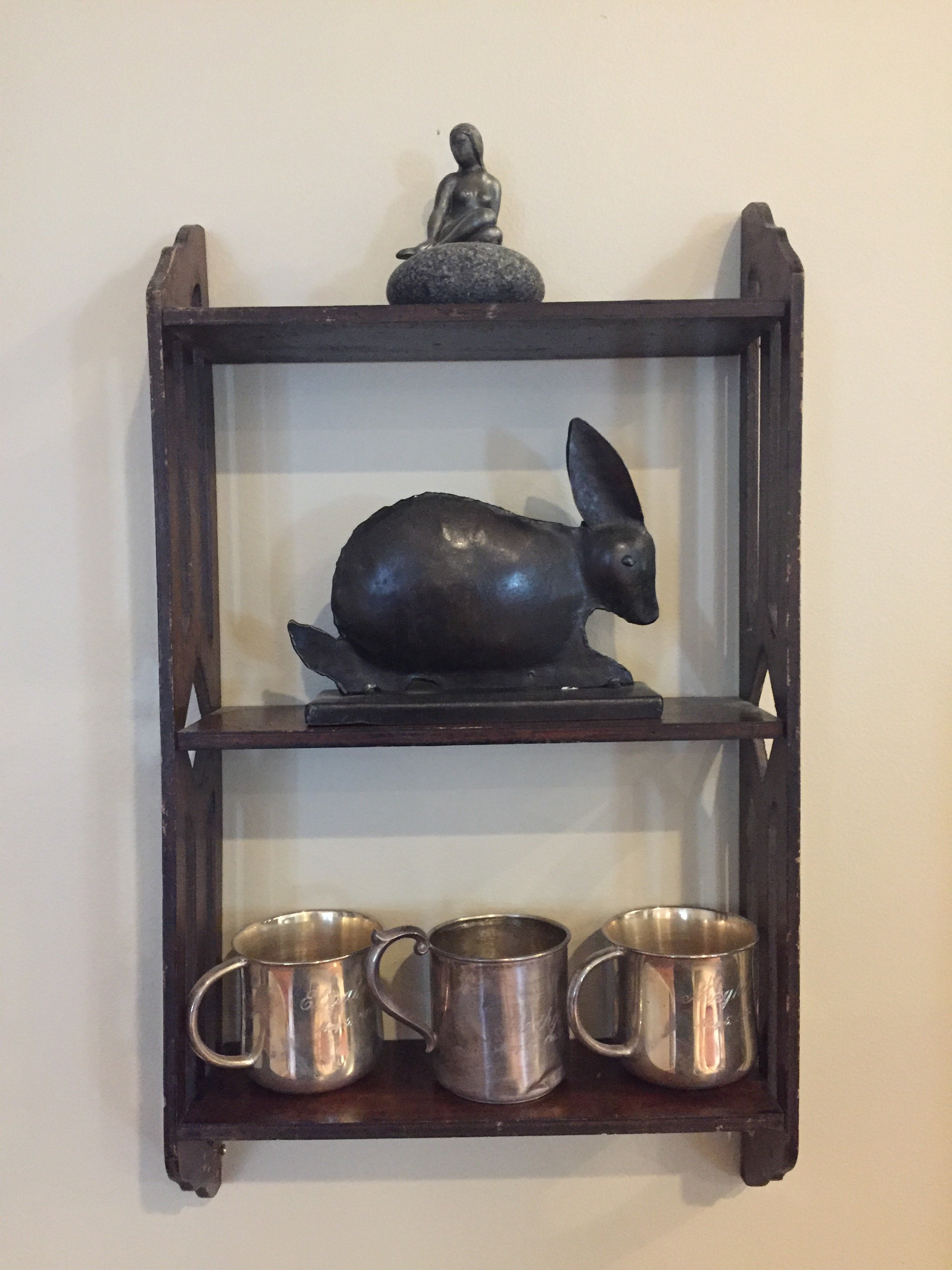 Display shelves and monogrammed silver cups