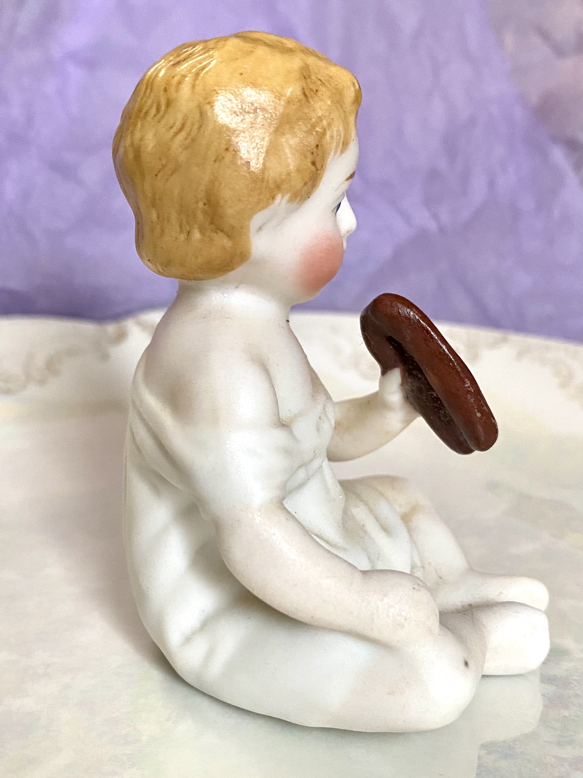 Figurine of a porcelain boy eating - right side rotation