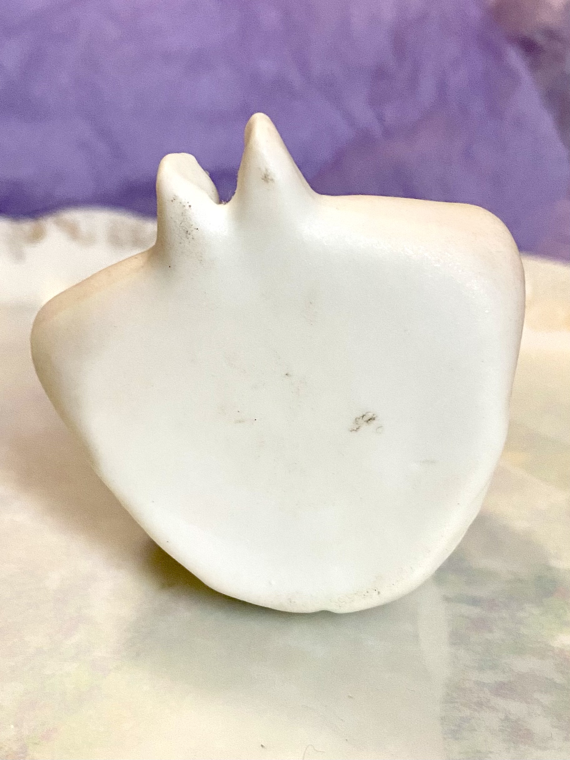 Figurine of a porcelain boy eating - underneath