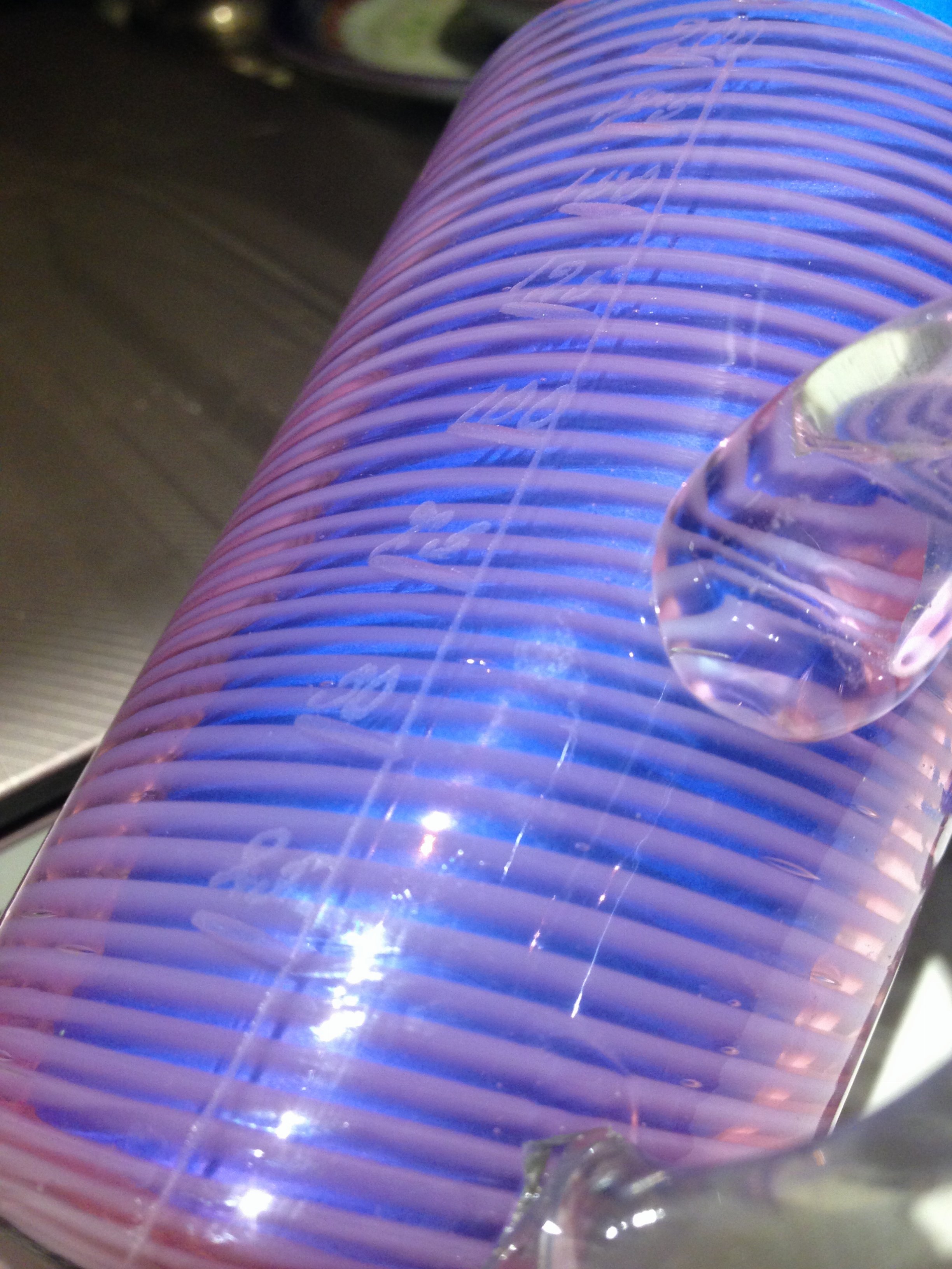 Glass measure with pink swirls